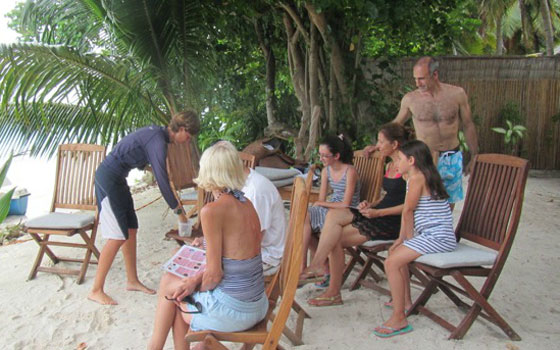 Training the guests before lacing the corals to coconut strings